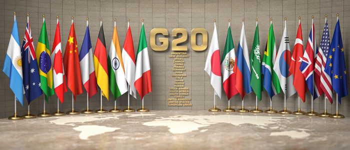 Row from flags of members of G20 Group of Twenty and list of countries in a conference room