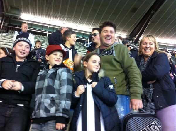 Adults and children at AFL game