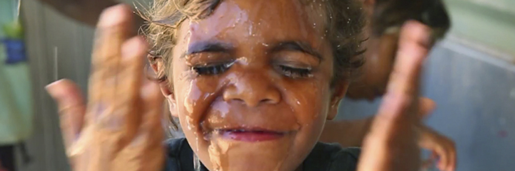 Boy washing his face