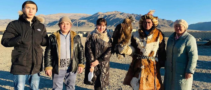 survey team in Mongolia stops for a visit with a falconer