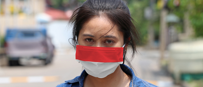 Woman wearing Indonesian Mask - looking worried