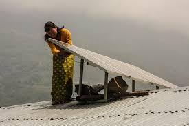 Engineer Selden checks a solar panel in Jangbit. Image by Ian Gill w