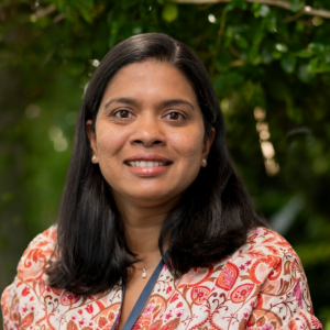 Profile Image of Muthuni Fernando. She has long dark hair and is smiling at the camers