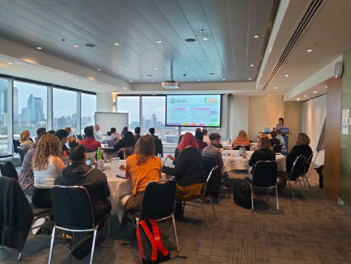 Person presenting to a room full of people