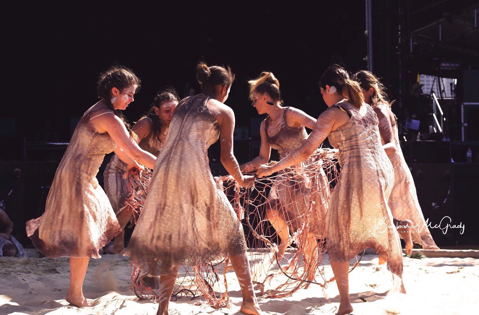 dancers in a circle with netting