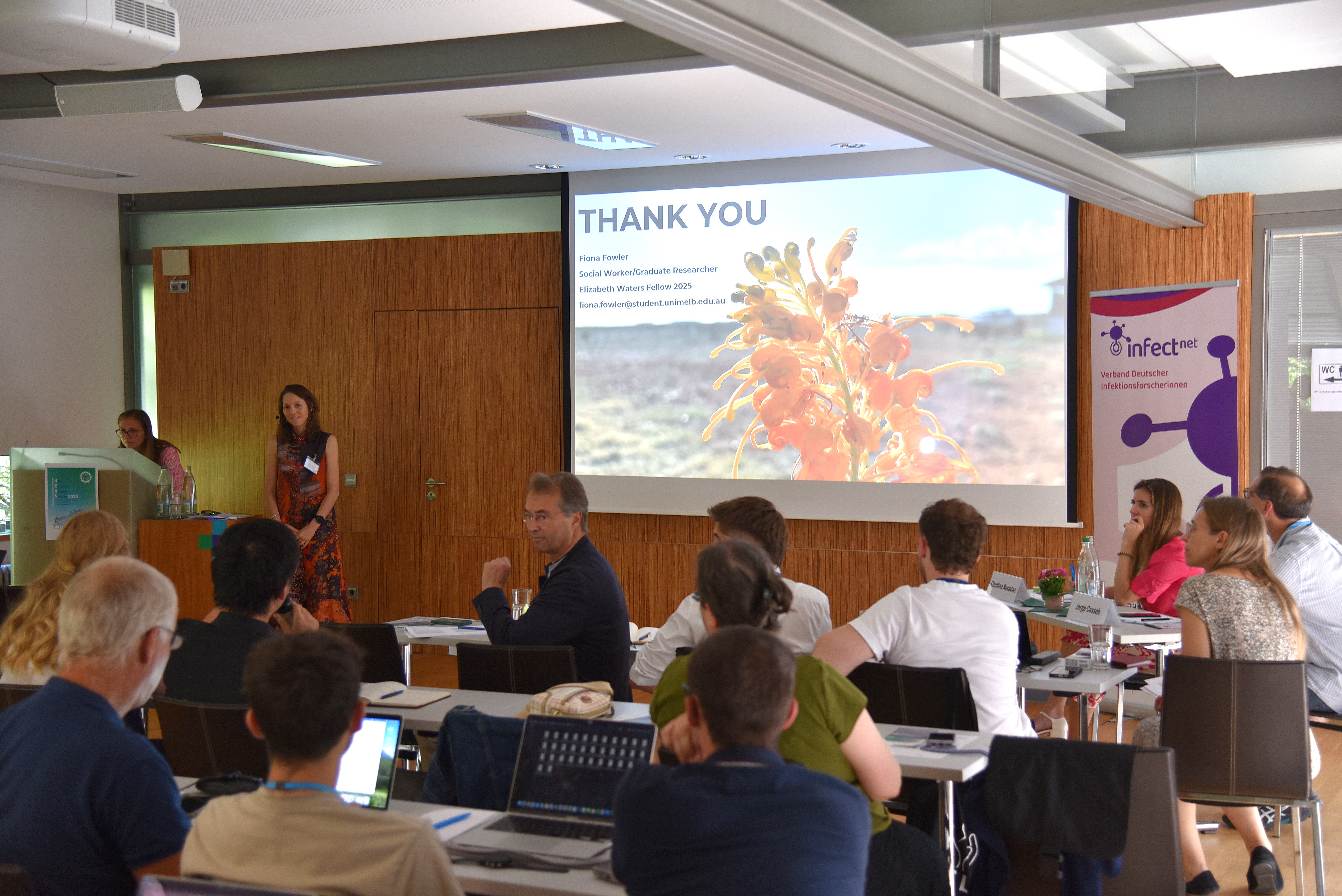 Picture of a woman presenting at a conference
