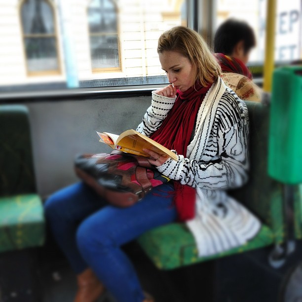 Allison Milner reading on a Melbourne tram