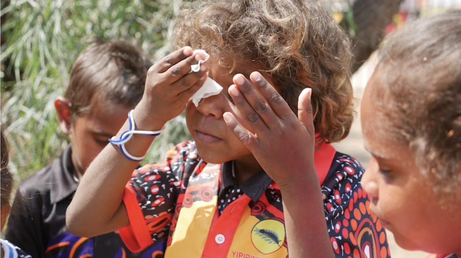 young child cleaning their face