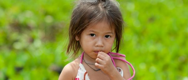 Portrait of asian girl, cute child eat a mango
